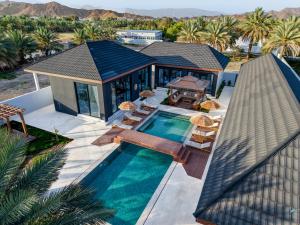 an aerial view of a house with a swimming pool at The Reef Villa in Bahlāʼ