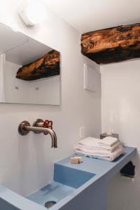 a bathroom with a sink and a faucet at Corippo Albergo Diffuso in Corippo