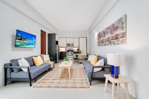a living room with two couches and a table at La Estadia in San Juan