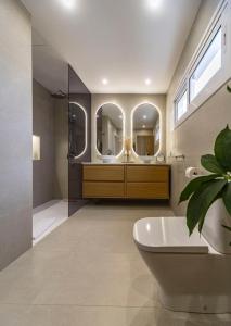a bathroom with a tub and a large mirror at Casa Dara's Sea in Playa Honda +16 photos