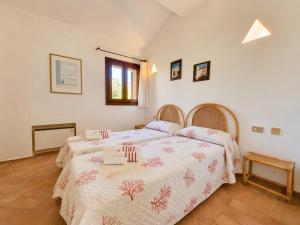 a bedroom with two beds and a window at Alba Ruja Residence 2 with Pool Close to All Amenities in Porto Cervo +4 photos