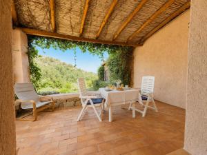 a dining room with a table and chairs on a patio at Alba Ruja Residence 2 with Pool Close to All Amenities in Porto Cervo