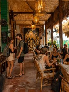 a group of people standing in a restaurant at Noahs Ark in Lamai