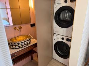 a bathroom with a washing machine and a washer and dryer at 8 persons Wellness Villa Tulpenacker in Roelofarendsveen