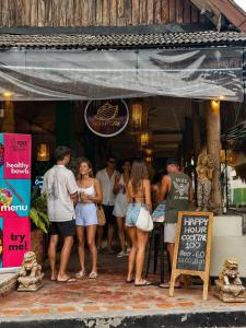 a group of people standing outside of a restaurant at Noahs Ark in Lamai