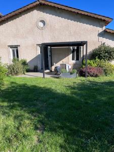 a building with an open door in a yard at GITE DE MIRAUVILLE in Apremont-la-Forêt