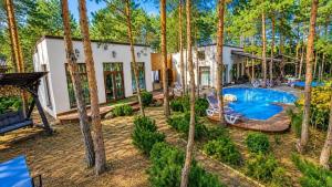 an aerial view of a house with a pool and trees at Дом в лесу 1dom club in Protsev