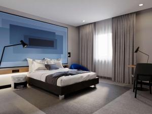 a bedroom with a large bed and a blue wall at IBIS LAGOS LEKKI in Lagos +77 photos