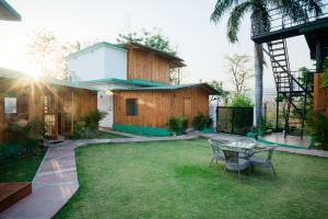 a patio with a table and chairs in a yard at Wildernest Resort in Kota Bāgh