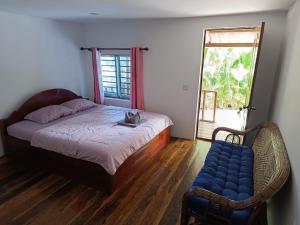 a cat is sitting on a bed in a bedroom at Stay in Paradise Koh Rong in Koh Rong Island