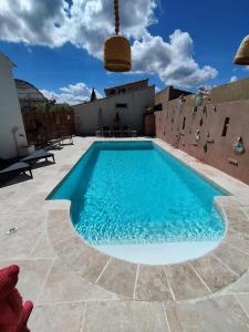 a swimming pool in the middle of a patio at Le gîte d 'Amandine in Boulbon
