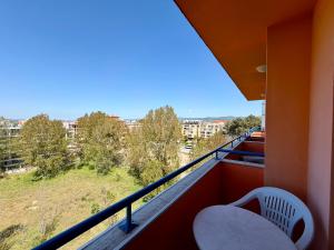 a balcony with a chair and an umbrella at Hotel Amaris in Sunny Beach