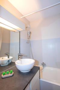 a bathroom with a large white bowl sink on a counter at L'Orée in Turckheim