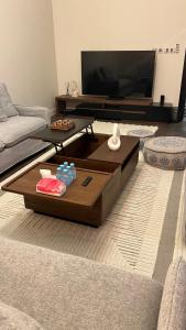 a living room with a couch and a coffee table at اليمامه in Al Yamāmah