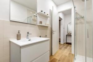 a white bathroom with a sink and a shower at Ser Lapo - Dimora storica a Prato in Prato +38 photos