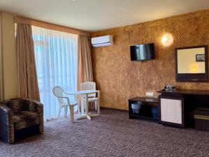 a hotel room with a table and a television at Hotel Amaris in Sunny Beach +40 photos