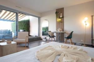 a bedroom with a large bed with a large window at L'Orée in Turckheim