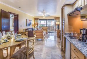 a kitchen and living room with a table and chairs at Meliá Puerto Vallarta in Puerto Vallarta