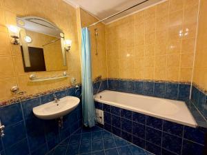 a bathroom with a bath tub and a sink at Hotel Amaris in Sunny Beach