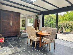 a dining room with a wooden table and chairs at La Maison des Eléphants in Vivonne