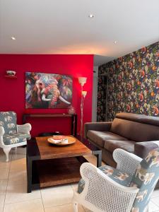 a living room with a couch and a table at La Maison des Eléphants in Vivonne