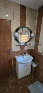 a bathroom with a sink and a mirror at Apartament WLA in Barcice