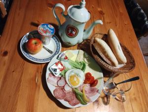 a table with two plates of breakfast food on it at Prázova Bouda in Dobré +5 photos