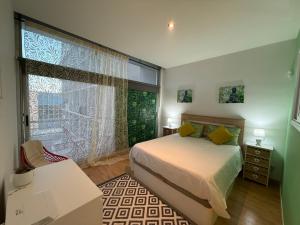 a bedroom with a bed and a large window at Villaverde light & terrace in Madrid +47 photos
