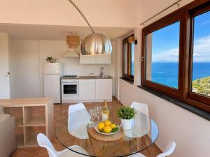a kitchen with a table with a bowl of fruit on it at Villa Rosmary in Massa Lubrense