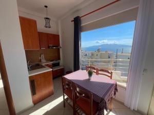 a kitchen with a table and a view of the ocean at Sea Gate Apartments in Sarandë