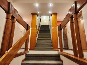 a flight of stairs in a building with wooden beams at Hotel Piero in Villa Mercedes