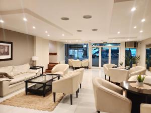 a living room with couches and tables and chairs at Hotel Piero in Villa Mercedes
