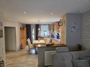a living room with a kitchen and a dining room at Haus Küstenheide in Cuxhaven