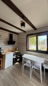 a kitchen with a white table and chairs in a room at Наше Місце in Krymno +57 photos