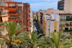 an aerial view of a city with palm trees and buildings at Azul. Cómodo, bonito y céntrico in Calpe