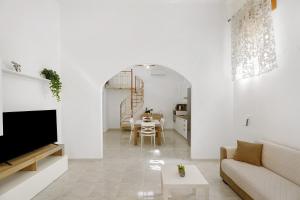 a white living room with a couch and a table at Angel's House in Sarno
