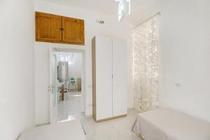 a white room with a bed and a sliding door at Angel's House in Sarno +18 photos
