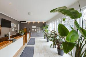 a hallway with potted plants in a lobby at Hostel SLEPS in Augsburg