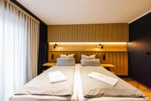 a bedroom with two beds with towels on them at Hostel SLEPS in Augsburg +16 photos