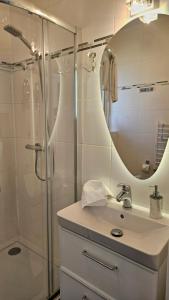a bathroom with a sink and a shower with a mirror at Comfort Willa in Jurata +43 photos