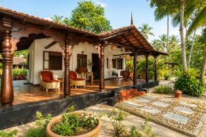 a house with a wooden pergola at Amritara A Beach Symphony in Mararikulam