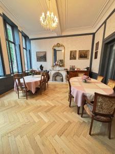 a dining room with two tables and a fireplace at Experiencebruges in Bruges