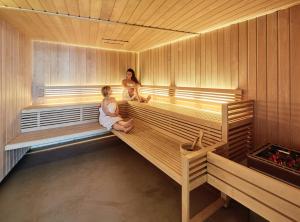 two women are sitting in a sauna at Exeter Hotel in Reykjavík