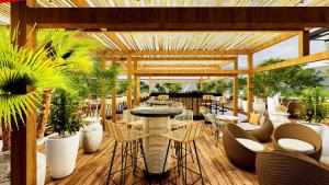 a patio with tables and chairs and plants at IBIS LAGOS LEKKI in Lagos