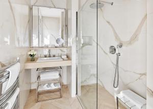 a bathroom with a shower and a sink at Hôtel Belles Rives in Juan-les-Pins +56 photos