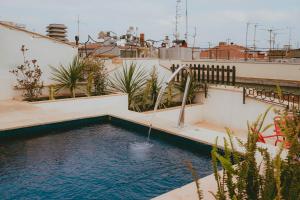 a swimming pool on the roof of a house at Aparthotel Casa Fages by Fimedhotels in Figueres