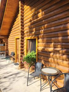 a wooden building with chairs and tables in front of it at Woodhouse in Eger