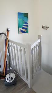 a white stair railing with a picture on the wall at Appartement T2 face au golf in Buzet-sur-Tarn