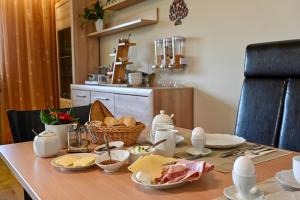 a wooden table with food on it in a kitchen at Pension Schöpke in Bad Staffelstein