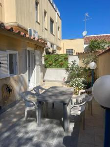 a patio with a table and chairs on a balcony at Apartment with garden PERLA NERONIANA in Anzio